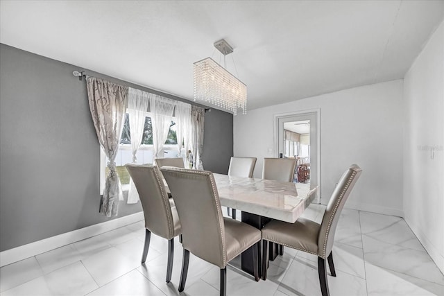 dining room featuring a wealth of natural light and a chandelier