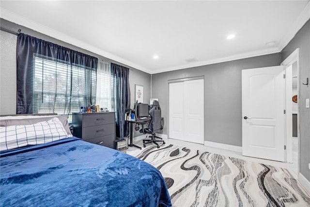 bedroom featuring crown molding and a closet