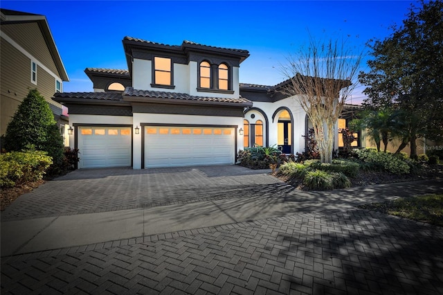 mediterranean / spanish home featuring a garage