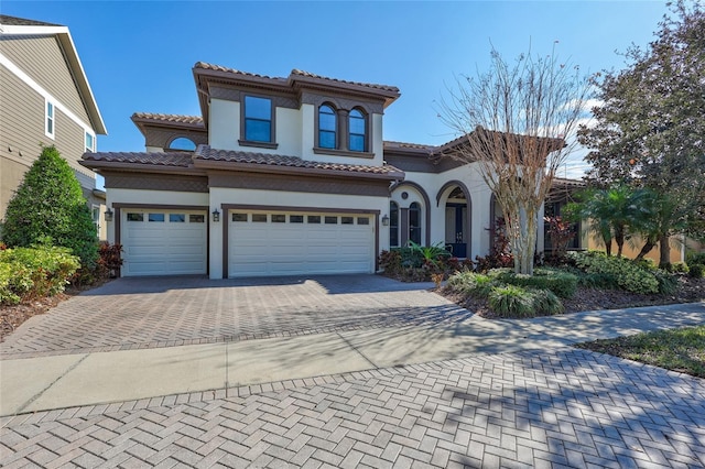 mediterranean / spanish-style home with a garage