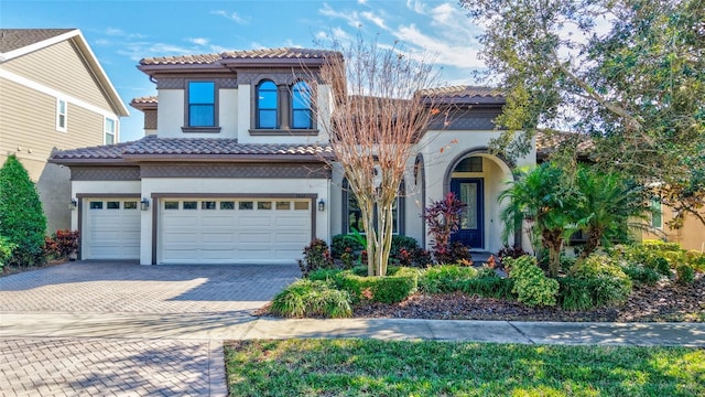 mediterranean / spanish-style home with a garage