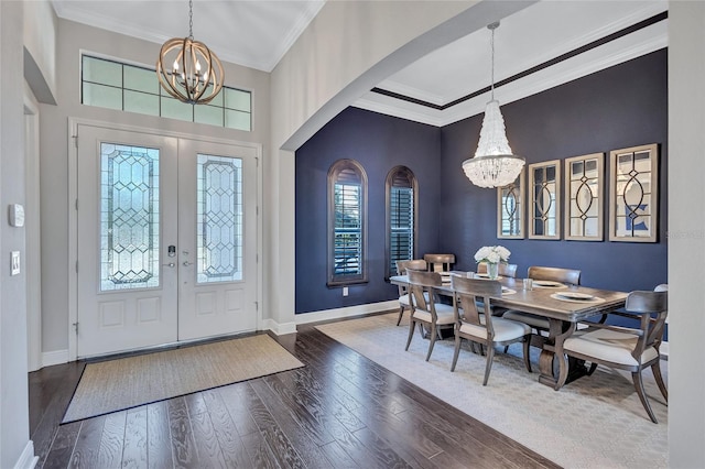 foyer featuring ornamental molding, french doors, a chandelier, and hardwood / wood-style flooring