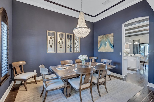 dining space featuring an inviting chandelier, ornamental molding, beamed ceiling, and dark hardwood / wood-style floors