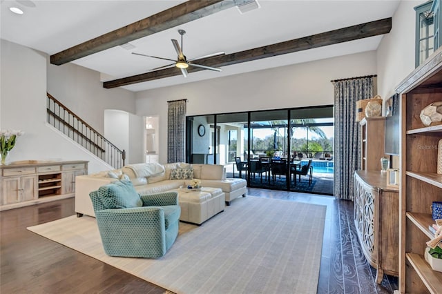 living room featuring beamed ceiling, ceiling fan, and wood-type flooring