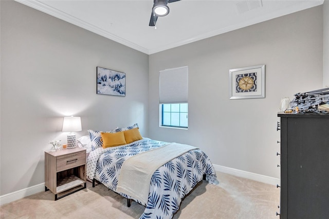 bedroom with ceiling fan, crown molding, and light carpet