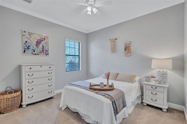 bedroom featuring ornamental molding, light colored carpet, and ceiling fan