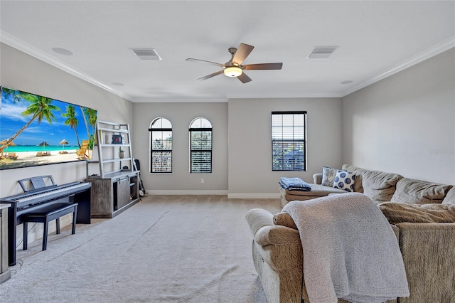 carpeted living room with ornamental molding and ceiling fan