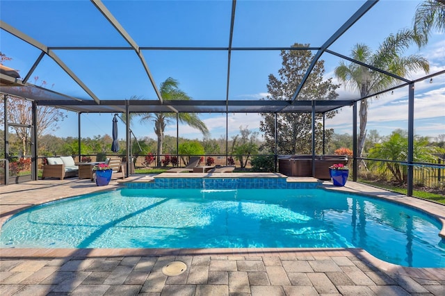 view of pool featuring a lanai, a hot tub, a patio, and an outdoor living space