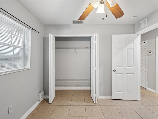 unfurnished bedroom featuring ceiling fan and light tile patterned floors