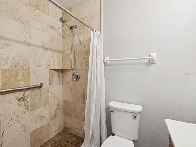 bathroom featuring walk in shower, vanity, and toilet