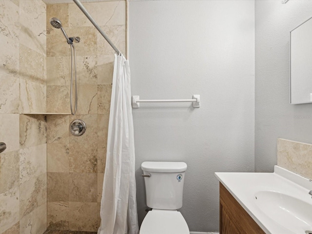 bathroom with toilet, vanity, and a shower with shower curtain