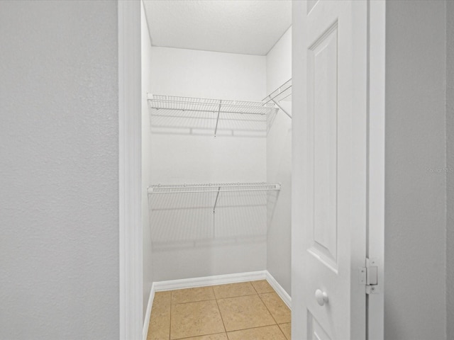 spacious closet featuring tile patterned floors