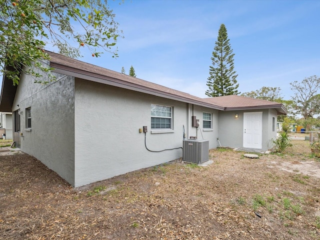 rear view of property with central AC