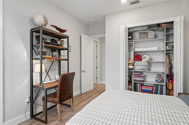 bedroom featuring light hardwood / wood-style floors and a closet