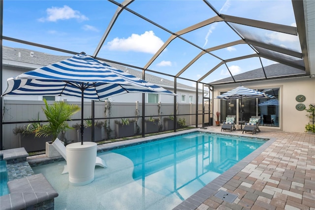 view of pool featuring a patio area and glass enclosure