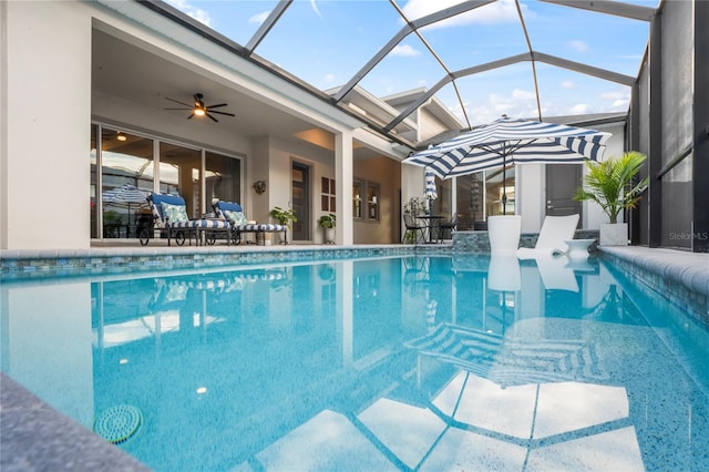 view of pool featuring a lanai, ceiling fan, and a patio area