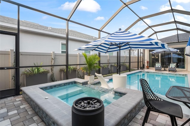 view of pool with an in ground hot tub, a lanai, and a patio