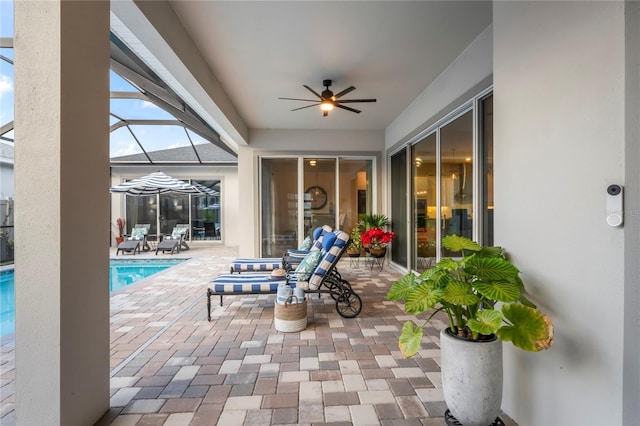 view of patio / terrace with a lanai and ceiling fan