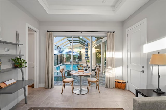 tiled dining room featuring a tray ceiling