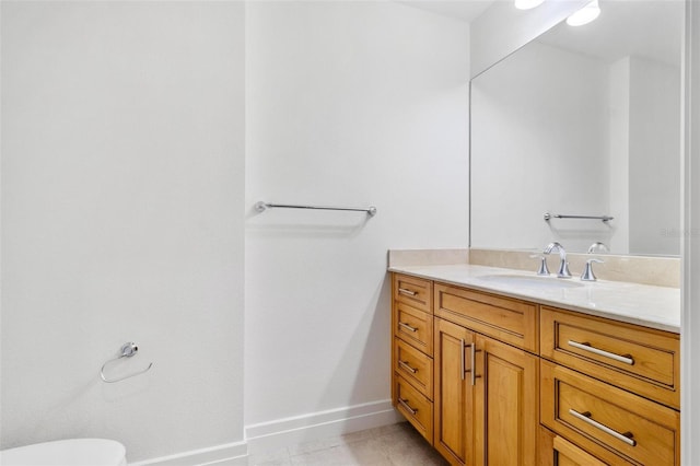 bathroom with tile patterned flooring, vanity, and toilet