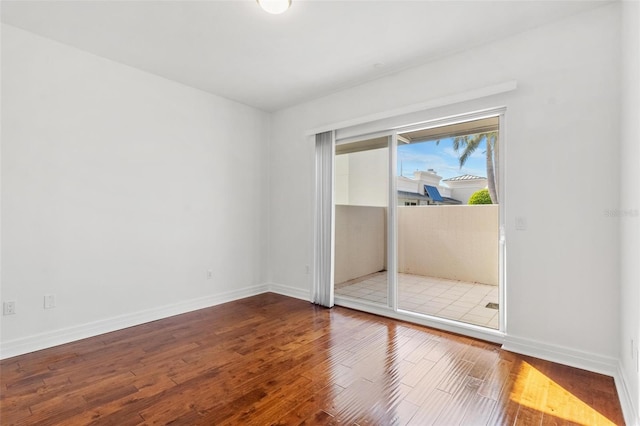 unfurnished room with hardwood / wood-style floors