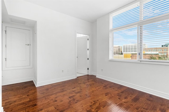 unfurnished room featuring dark wood-type flooring