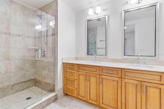 bathroom featuring tile patterned floors, a shower with door, and vanity