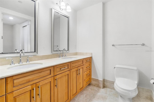 bathroom with tile patterned flooring, vanity, and toilet