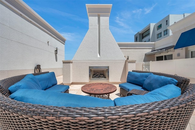 view of patio / terrace with an outdoor living space with a fireplace