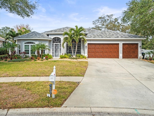 view of front of property featuring a garage and a front yard