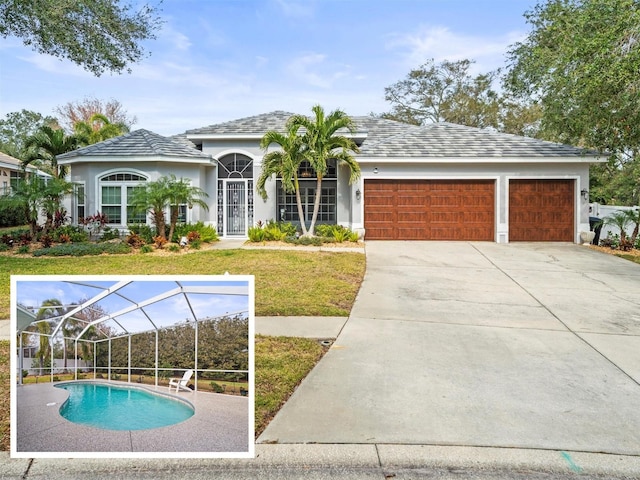 view of front of home with glass enclosure, a garage, driveway, stucco siding, and a front lawn