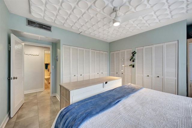 tiled bedroom with multiple closets