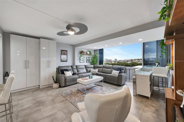 31 Island Way Unit 303, Clearwater Beach, FL 33767 - living area with ceiling fan and light tile patterned floors