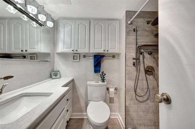 31 Island Way Unit 303, Clearwater Beach, FL 33767 - bathroom featuring toilet, tile walls, tiled shower, and vanity
