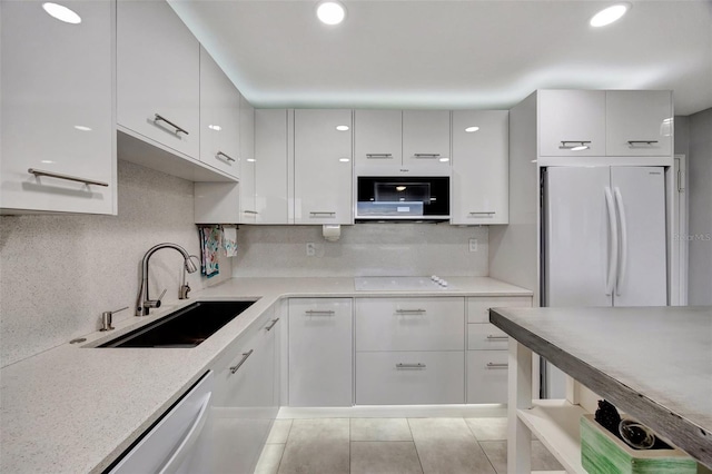 31 Island Way Unit 303, Clearwater Beach, FL 33767 - kitchen featuring a sink, modern cabinets, white appliances, and white cabinetry