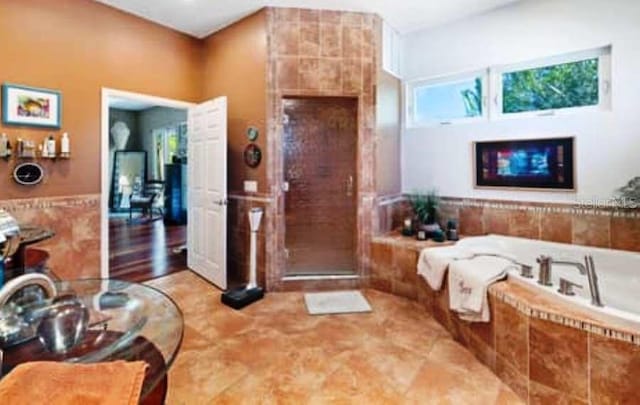 bathroom with separate shower and tub