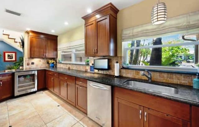 kitchen with sink, dishwasher, backsplash, hanging light fixtures, and wine cooler