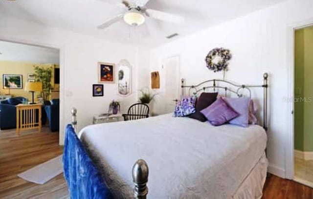 bedroom with ceiling fan and dark hardwood / wood-style floors