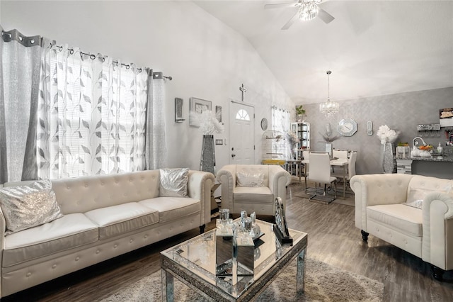 living room featuring lofted ceiling, hardwood / wood-style floors, and ceiling fan with notable chandelier