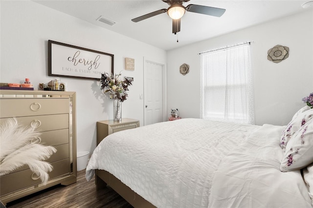 bedroom with dark hardwood / wood-style flooring and ceiling fan