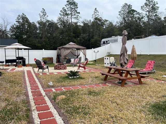 view of yard featuring a gazebo and a fire pit