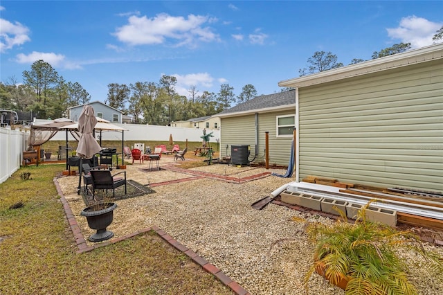 view of yard featuring cooling unit, an outdoor fire pit, and a patio