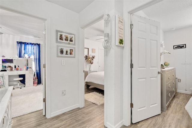 hallway with light hardwood / wood-style flooring