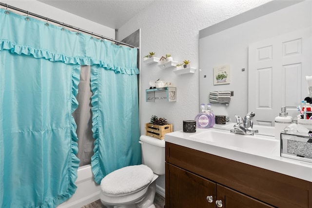 full bathroom featuring vanity, toilet, a textured ceiling, and shower / bath combo