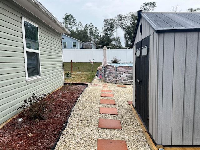 view of yard with a shed and a swimming pool