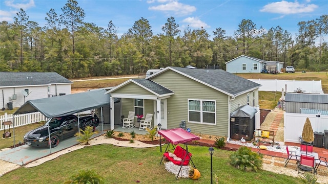 view of front of house with a carport, a front yard, and covered porch