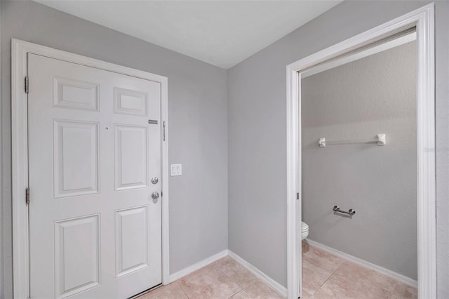 bathroom featuring toilet and tile patterned flooring