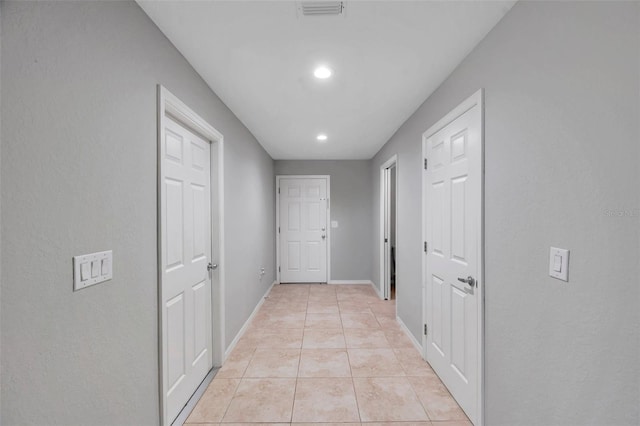 hall featuring light tile patterned flooring