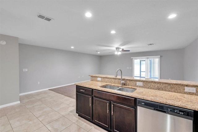 kitchen featuring light stone counters, stainless steel dishwasher, sink, and dark brown cabinets