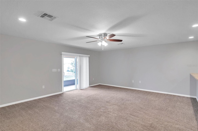 spare room featuring a textured ceiling, ceiling fan, and carpet flooring